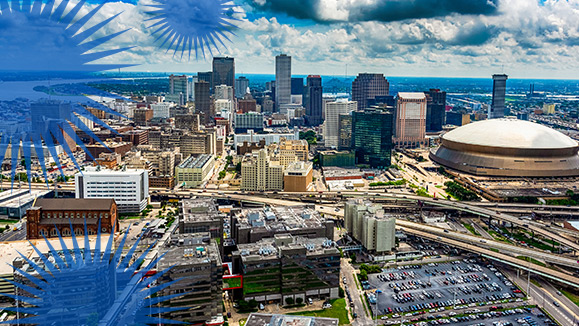 An aerial view of downtown New Orleans office buildings, stadium and Mississippi River.